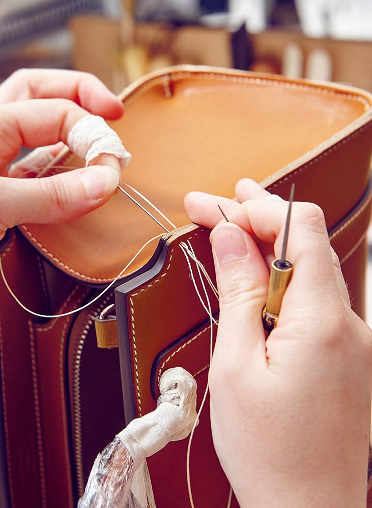 Artisan working on leather in workshop